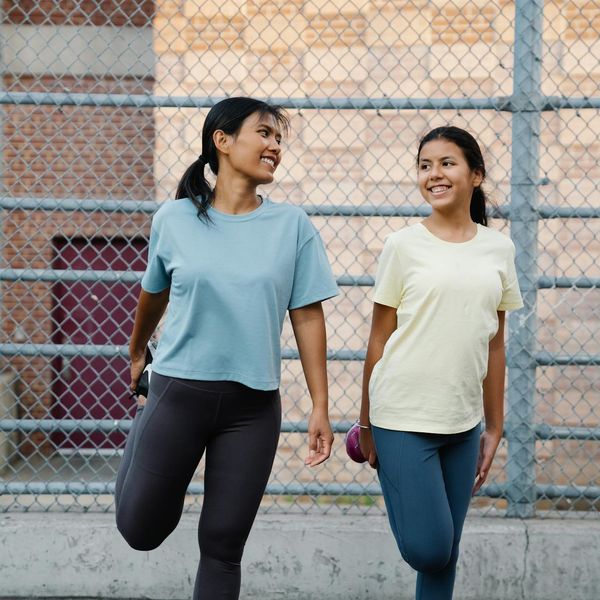 Smiling woman in sportswear feeling energized after a workout.